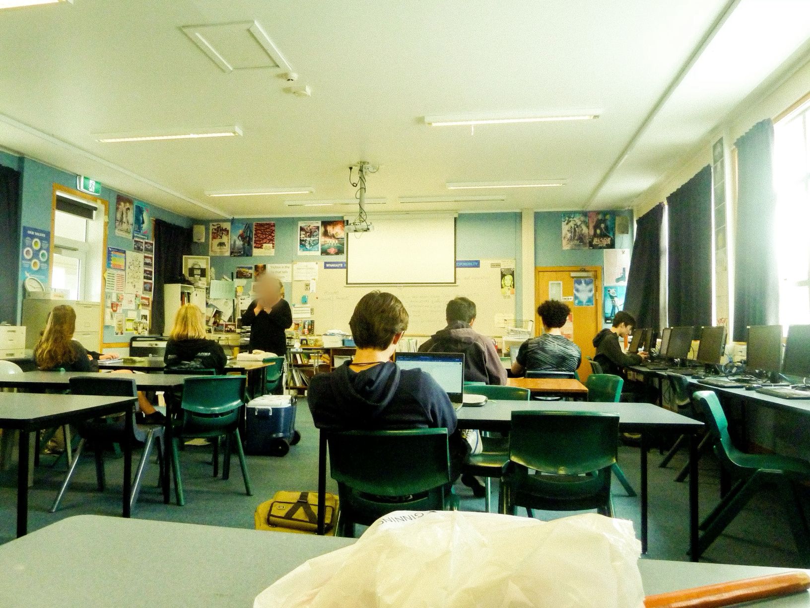 A full secondary classroom mid-lesson, seen from the back of the room